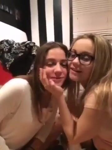 Sisters kissing in front of their brother on camera